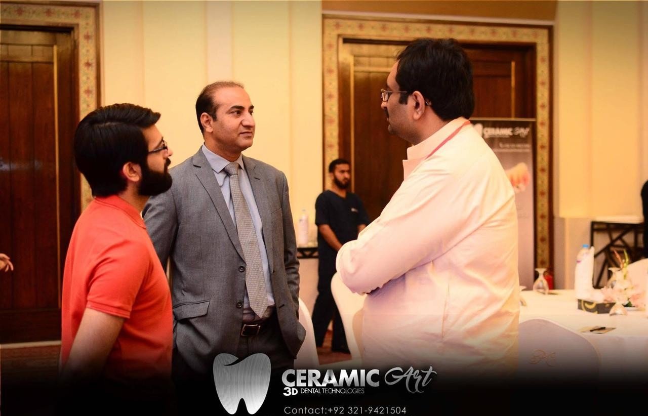 Three visitors in conversation between sessions