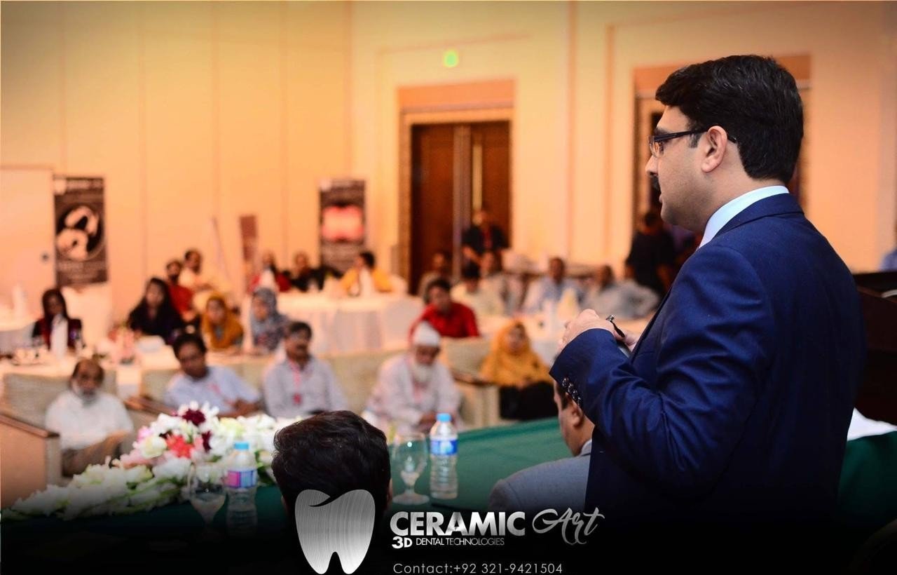 A presenter addressing the seated audience