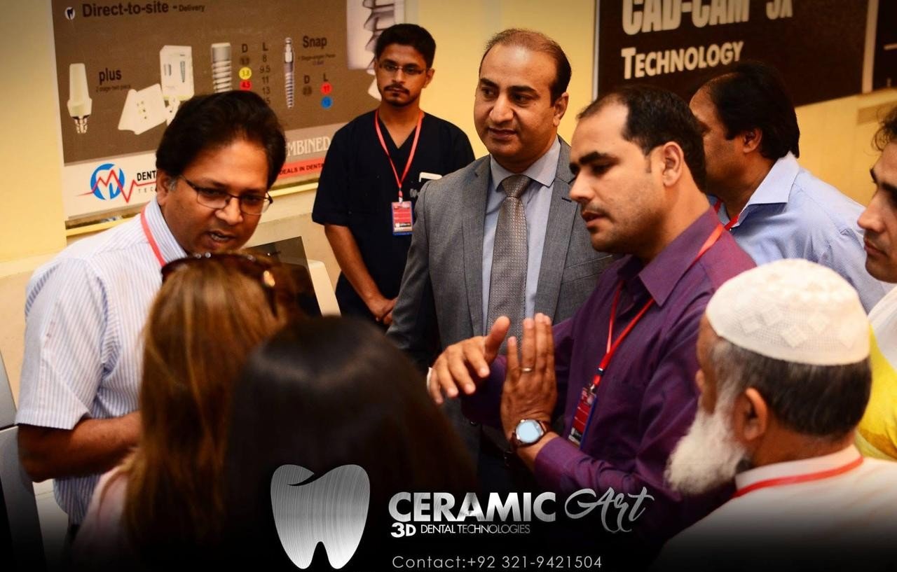 Visitors gathered around a display of implant components