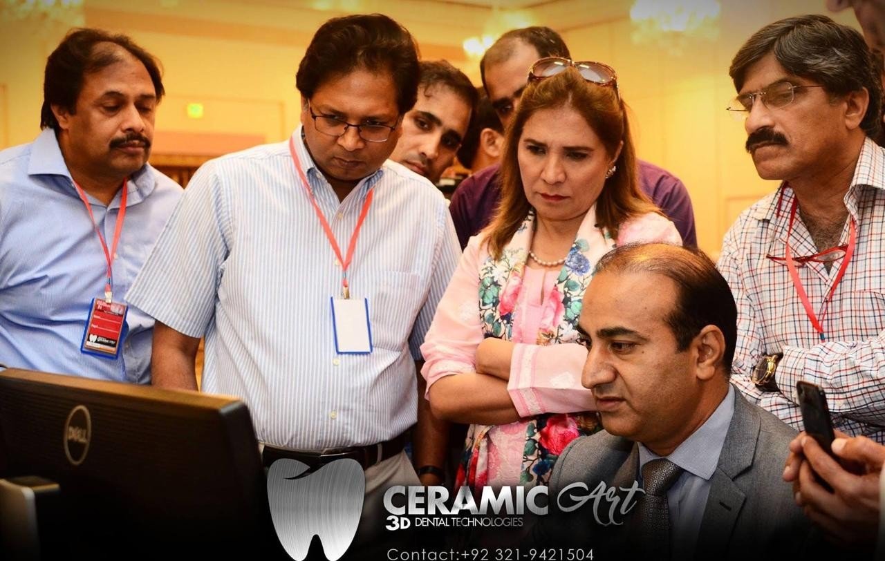 Dentists watching a CAD design demonstration on screen